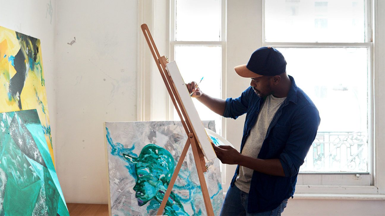 man painting on a canvas for stress relief